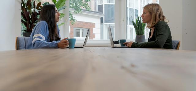 woman in blue long sleeve shirt sitting beside woman in black long sleeve shirt by airfocus courtesy of Unsplash.